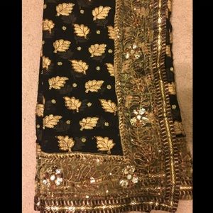 Gorgeous black and gold georgette saree with stone work